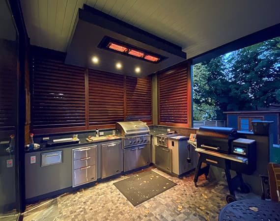 short wave icr series heater by solaira mounted in the ceiling above an outdoor kitchen