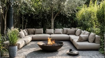 a fire bowl on a gravel patio surrounded by a sectional couch